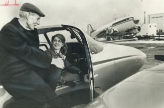 Flier-Novelist-Historian Cyril Caunter checks map with pilot professor Daphne Schiff, Prof