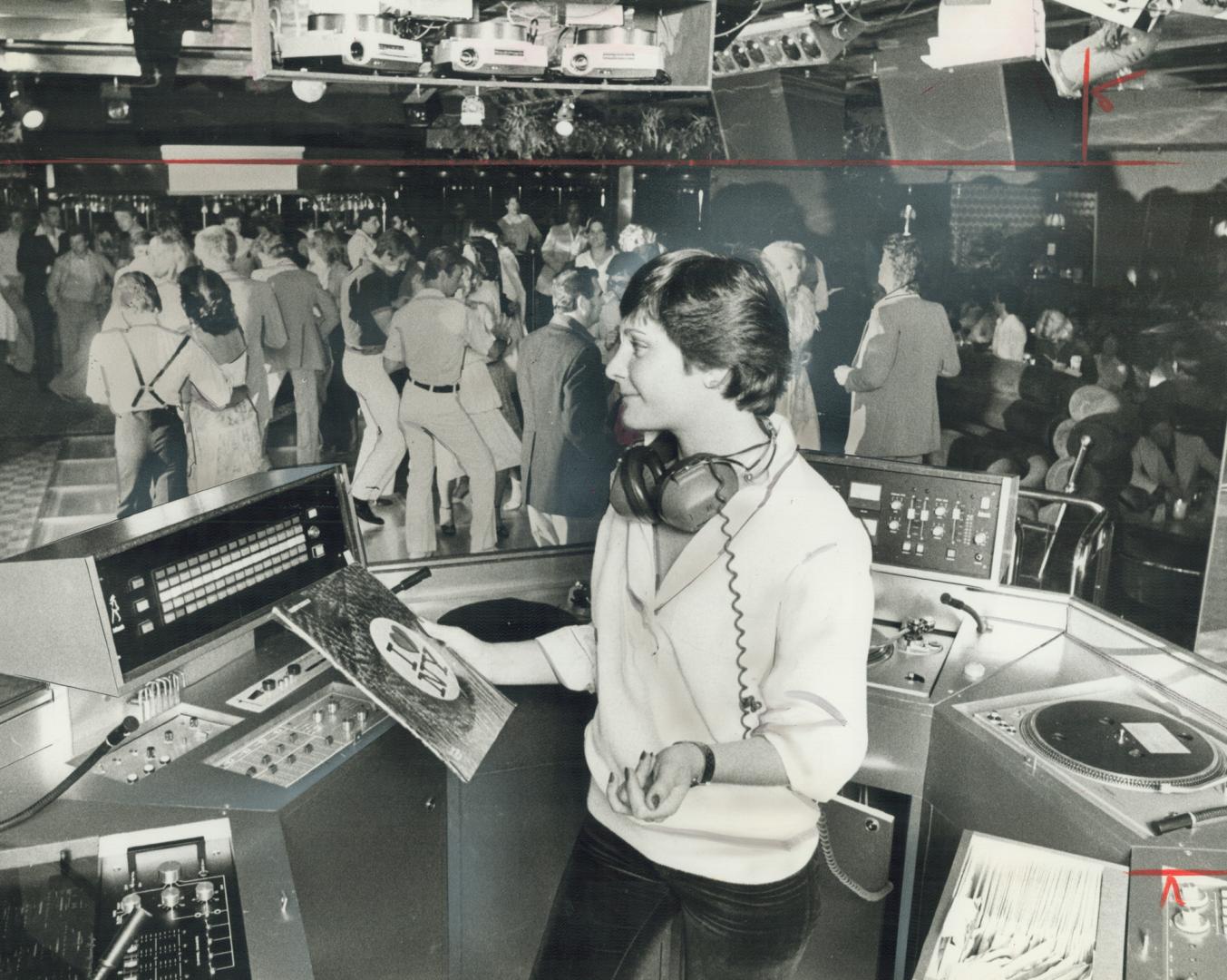 Disc Jockey Vicky Watson masterminds the console at Misty's disco, the new glitzy-elegant spot in the Airport Hilton Hotel. [Incomplete]