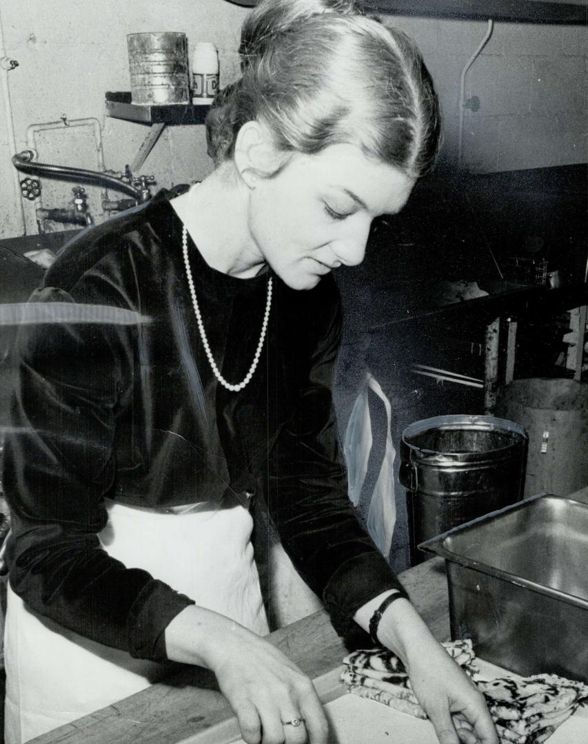 Actress Flora Lojekova off stage, She's putting sweet, walnut filling in Slovak pancakes