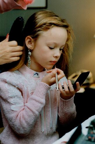 Thora Birch applies a little more gloss to 'lighten' the lipstick