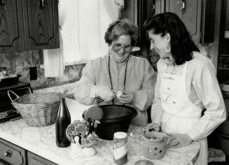 Delicious dishes: Carla Azevedo, right, works with Portuguese women such as Maria Pereira to get their recipe and techniques for a cookbook of Portuguese dishes she is writing