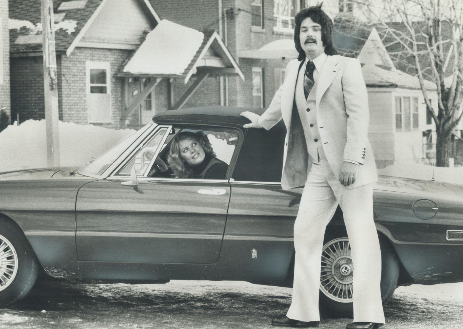 Rich Dodson, rock musician, models Angelo Rosso's spring linen suit with his wife, Mary-Lynn, looking on