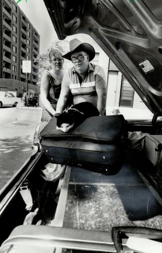 All set to roll: Ted Greenslade, his wife and the family cat check out the trunk of their 10-year-old Meteor which they expect will take them in safety and comfort to the coast of British Columbia