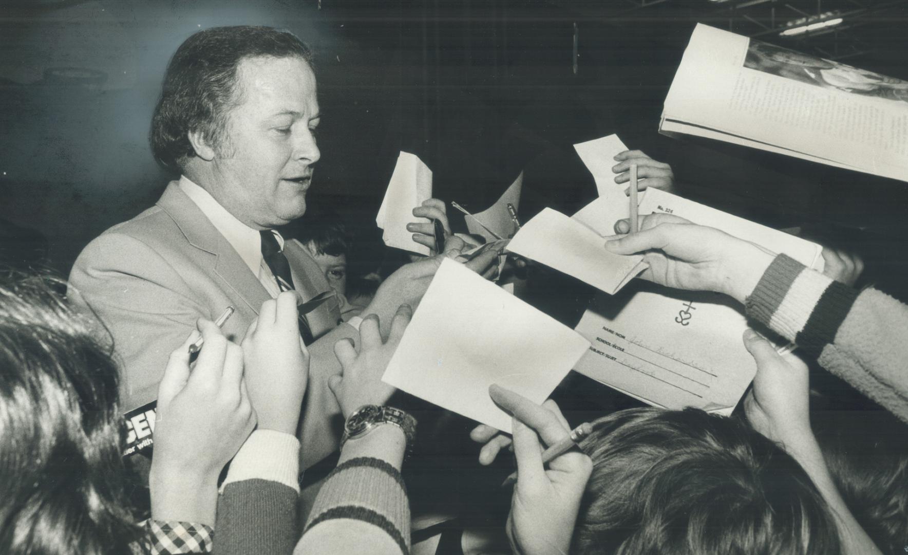 Celebrity, Hockey broadcaster Brian MacFarlane was swamped by autograph seekers at the end of a book called Peter Puck, talked about hockey and how to play a fair game