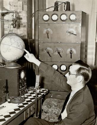 Half-way around the atlas - and Bruce Carruthers of Toronto points out a town in India which he has contacted on his own small broadcasting and receiving radio set