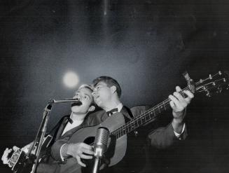 Sweet and low across the soft summer ai come voices of Andy Hermant and Rick Fielding of Blue Grass Ramblers, a popular folk-singing group [Incomplete]