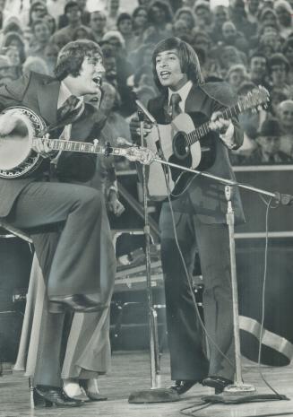 Getting into the swing of the song, New Christy Mintrel Bill Zorn (left), partners John Anthony at concert by U