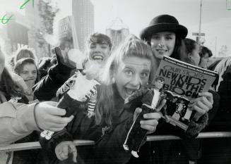 Kids fans get Tickets Early. Kari Selwood, 16, of Dounsview, holds her Donny doll in front of her and Laura Armstrong (Wearing hat) displays a book ab(...)