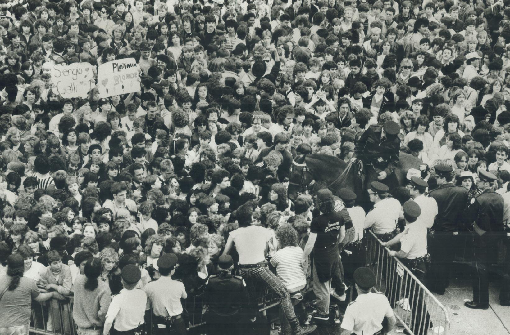 Mod scene at city hall party. Many fans were crushed against barricades as more than 20,000 people jammed into Nathan Phillips Square for a Toronto bi(...)