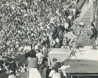 Crowd of more than 75,000 listens in delight as Mick Jagger belts out the group's hits at Buffalo's Rich Stadium