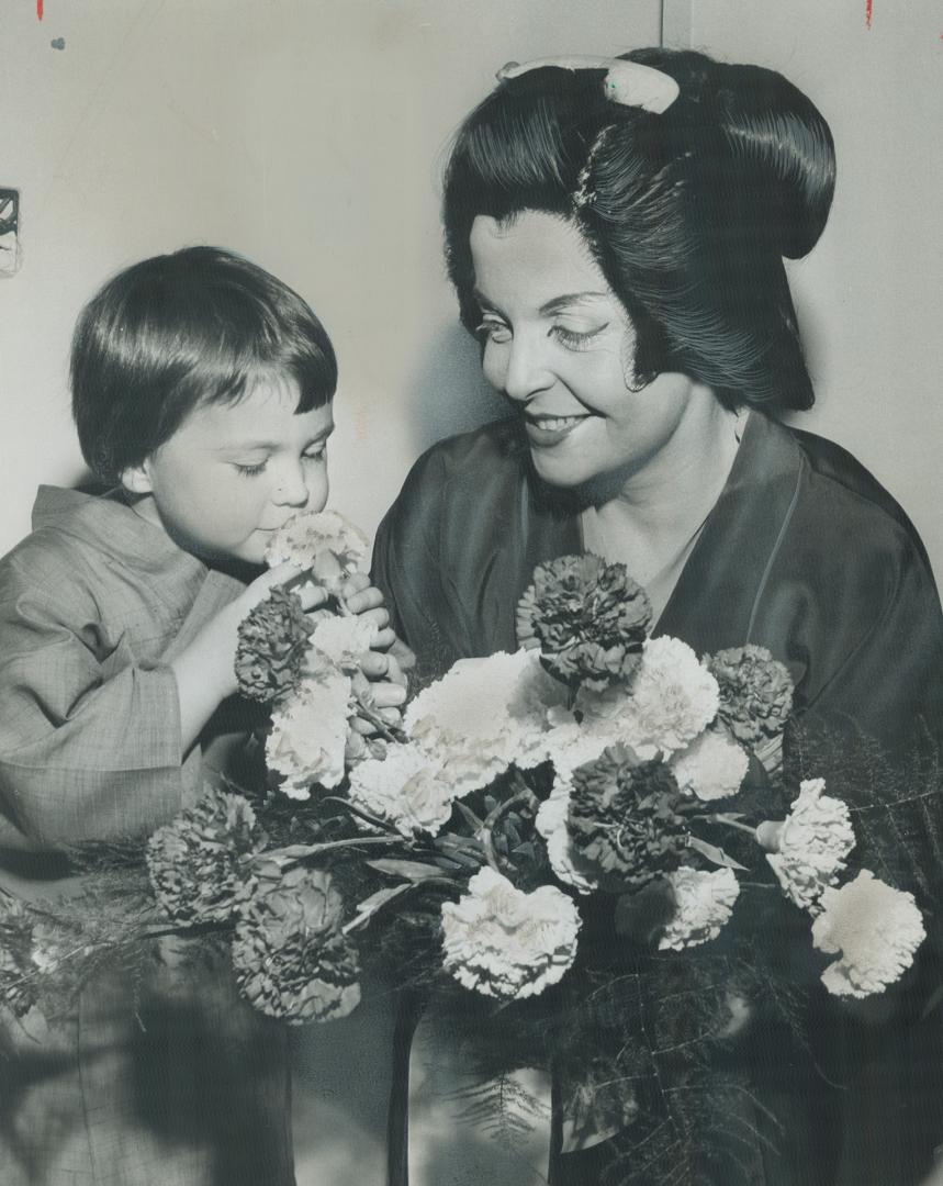 Sweet smell of success and of flowers is enjoyed ty Tricia Adams with Pat Rideout