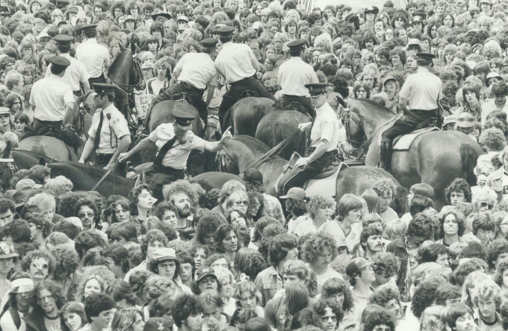 Rowdy rockers. Police on horseback try to control fans lined up outside Exhibition Stadium for Canadian World Music Festival yesterday. Metro police a(...)