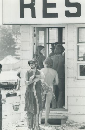 Studiously ignored by other restaurant patrons, one of the fans at the Mosport rock festival waits, nude, in line to pick up a snack at one of the food concessions