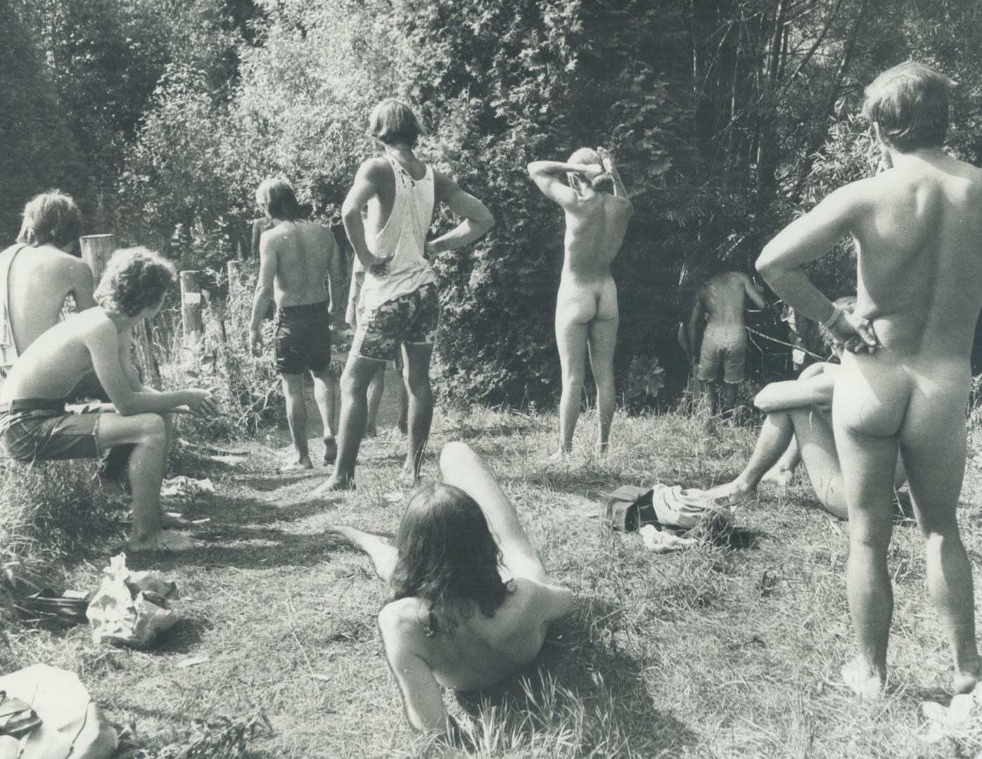 Enjoying the sun fully, young people attending the Mosport Strawberry Fields rock festival bask in one of the wooded glens on the 500-acre property. E(...)