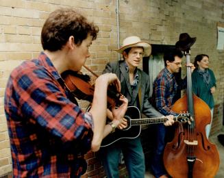 Members of the Grievous Angels, Peter Jellard, Chuck Angus, Tim Hadley, and Michelle Rumball, pound out some down-home, foot-stomping music