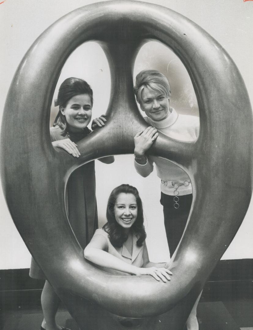 Pretty Trio takes a preview peep through one of the pieces set up for tonight's Guggenheim exhibition at the Art Gallery of Ontario. Mary Wolverton (t(...)