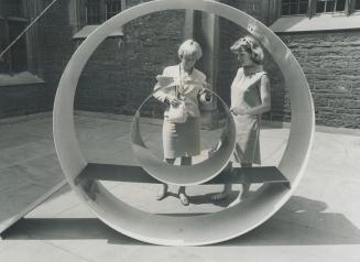 United Sculpture by British sculptor David Annesley draws attention of two visitors to display of the works of seven artists in the quadrangle at Hart(...)