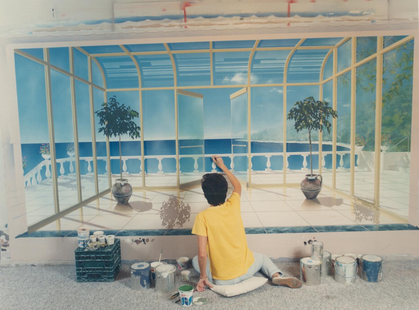 Left, Elizabeth Anselmo of Anselmo Art Studios works on a trompe I' oeil designed to brighten up a small, dark foyer