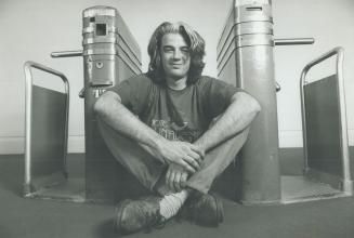 Institutional art: Windsor artist Robert Coyle poses in front of a pair of turnstiles, part of an exhibit now at the Civic Centre Art Gallery in Mississauga