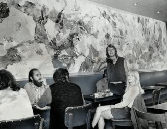 Jerry Santbergen stands in front of the 23-foot mural he painted for the Pilot Tavern by coating himself and his wife Naili (seated above) with paint (...)