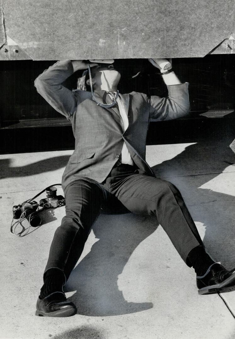 Toronto's first peek at the $100,000 sculpture was obtained when Str photographer Boris Spremo (below) sprawled at Nathan Phillips Square and stuck his camera inside the protective case