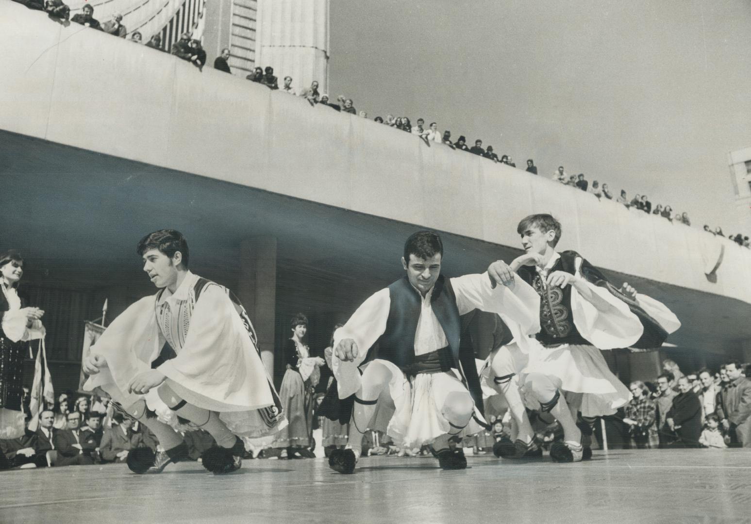 Three Greek dancers perform one of their country's national dances Saturday during a half four celebration in front of City Hall, part of a series of (...)