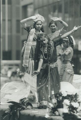 Traditional pose: Girls in flowing costumes perform a classical dance as Hindus take part in the Festival of the Chariots yesterday