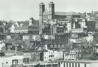 Right: Skyline of St. John's, the capital. Cosmopolitan in many respects . . . it is also very small-town, the writer observes. Newfoundlanders, says (...)