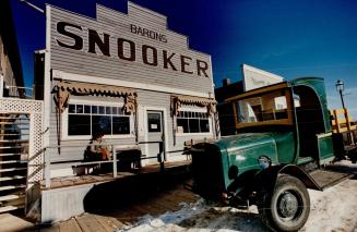 A cowboy snoozes outside the pool hall in Heritage Park