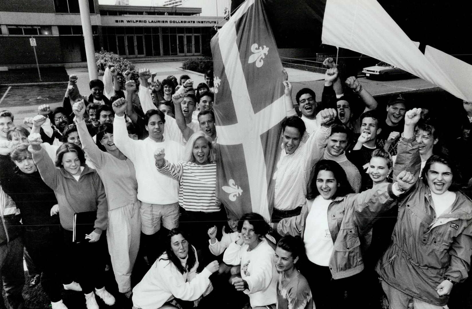 Boost for Unity: Students at Wilfrid Laurier Collegiate in Scarborough hoist the fieur-de-lys and the Canadian flag yesterday to show their faith in the country, despite the current crisis