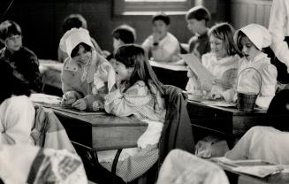 Grade 5 students, Amy Jones (left) and Jennifer MacFarlane, giggle in class