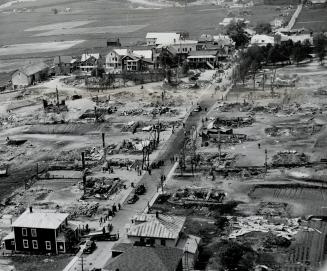 Another aerial view of burned-out village shows only chimneys standing gaunt amid the ruins