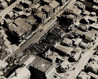 Destruction left by $1,200,000 fire that swept through the business district of Thetford Mines, Que