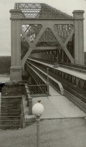 Impressive view of the Quebec bridge, showing the motor highway across the giant span between the railroad tracks