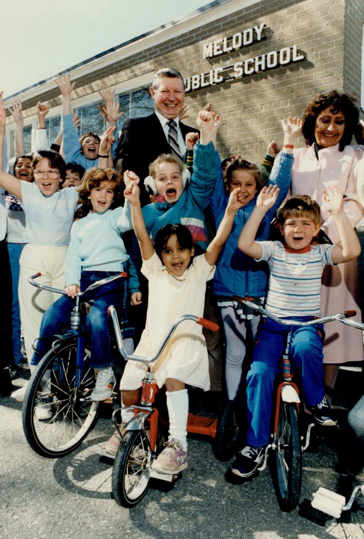 School supporters: Principal Gord Miller and parent Lolly Harrison are surrounded by Melody Public School students