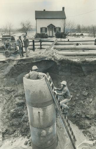 Marooned by a 10-foot trench. Bob and Kathy Rheaume woke up yesterday morning to find their home north of Oakville cut off from Highway 25 by a 10-foo(...)