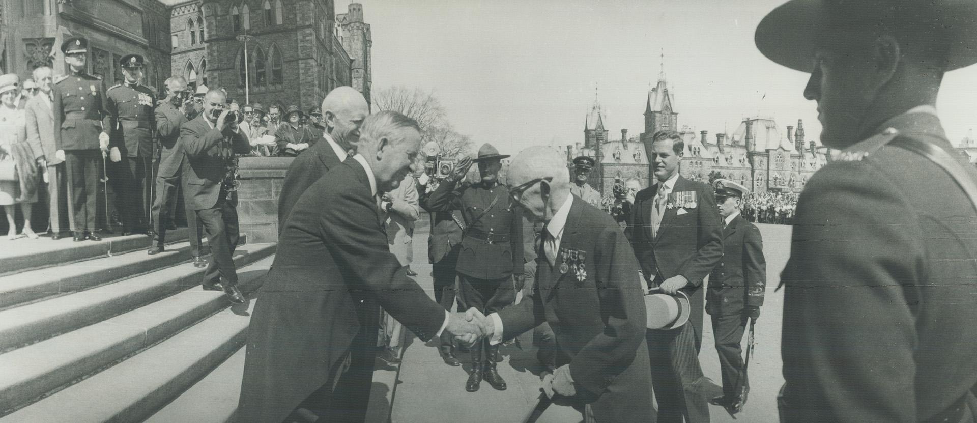 Prime Minister Pearson shakes hands with Chief Justice Taschereau