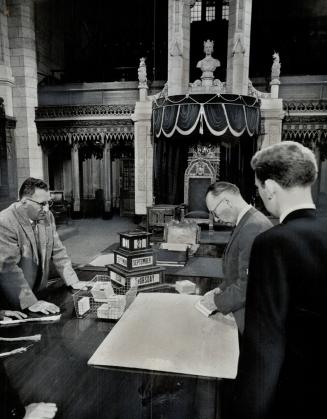 The seating plan for members is checked in preparation for the session