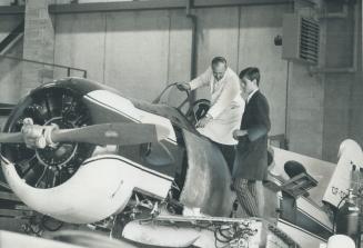 Airplanes can't fly unless they are efficiently maintained, and student Gerald Muckle (right) is learning how to do the job from George Cummings, an i(...)