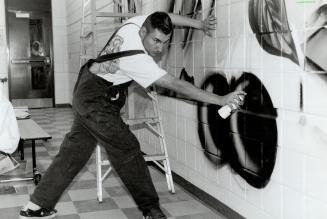 Arturo Parada Paints mural an cafeheica walls at west hill public school