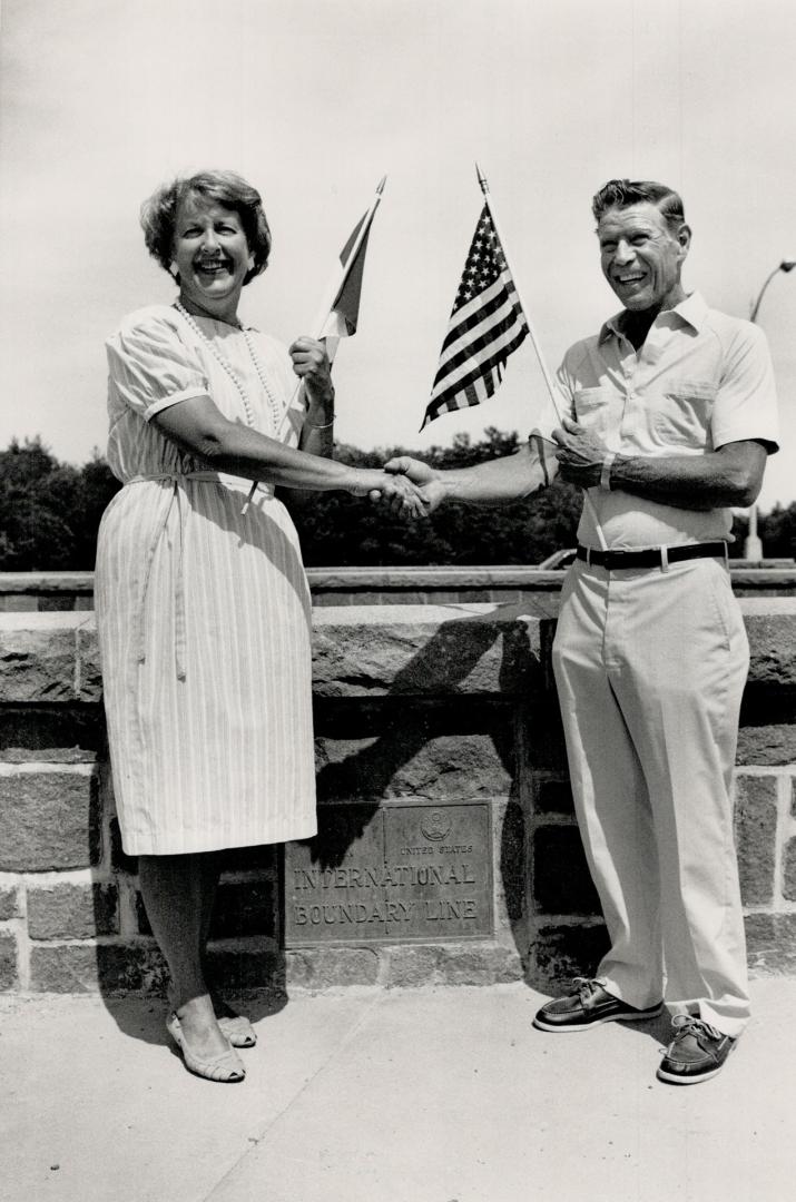 Scene of friendship: Elinor Rowins and Robert Kernehan shake hands on the Thousand Islands bridge, just as they did 50 years ago