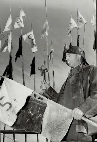 Jack Edmonstone, right, keeps the net buoys' flags in trim