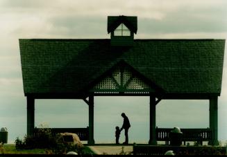 Peter Versaeval of Oshawa enjoys a breezy afternoon with his 4-year-old daughter Nicole on the Whitby Lions Promenade on the shore of Lake Ontario in (...)