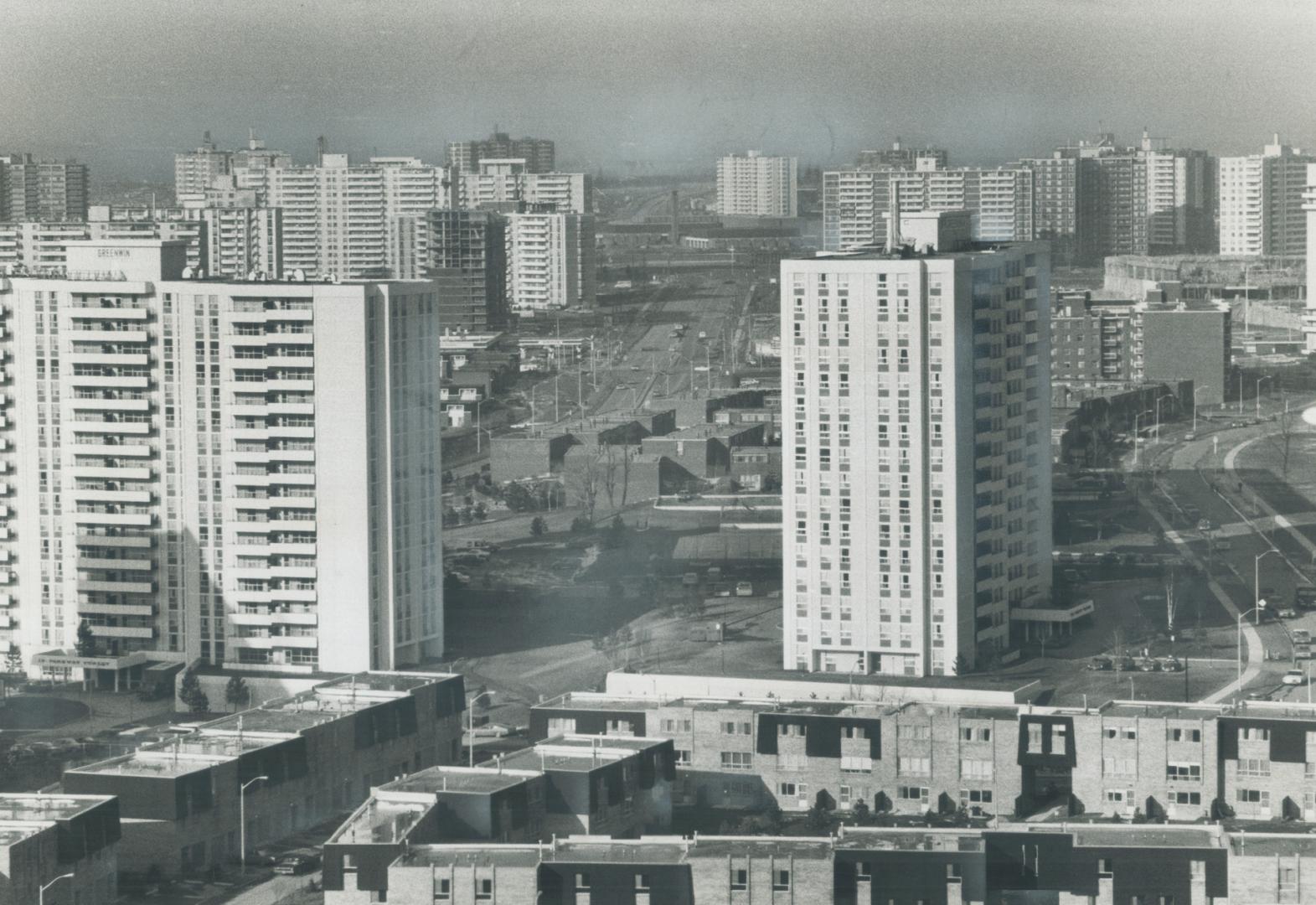 Image shows apartments dominate the skyline looking north across Highway 401 at Don Mills Road,…