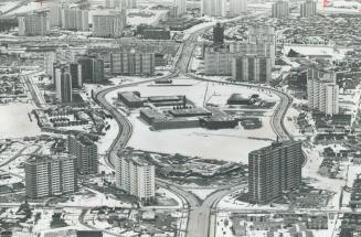 Image shows a view of a development of high-rises and townhouses along Don Mills Road, Toronto,…