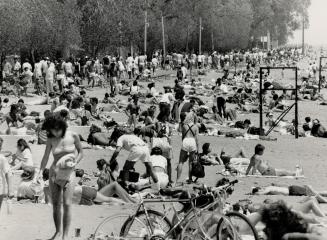 Tanning time, Sunshine and warmth lured many to the beaches yesterday as temperatures hit 24 degrees Celsius