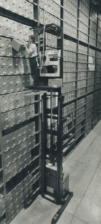 Frank Tomassi needs a forklift to get at files yesterday at the new Metropolitan Toronto Archives and Records Centre on Spadina Rd. Just south of Casa(...)