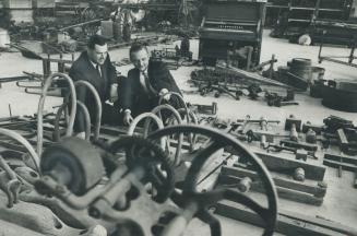 Eric Lawson, project officer, and Leonard Johnson, acting chief curator, discuss pile of junk