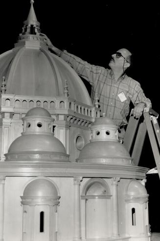 A Model church. Science Centre information officer Brian Stein examines a model of a centrally planned church, part of the Leonardo da Vinci: Engineer and Architect exhibition