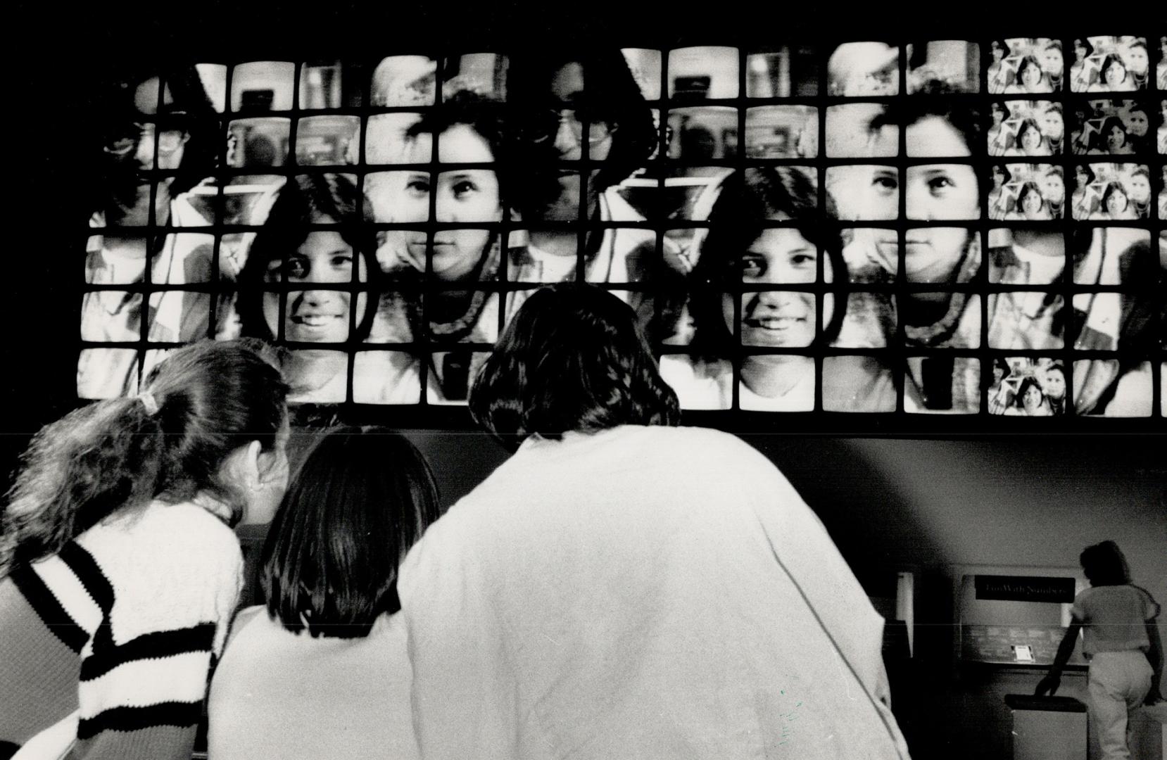 Adria Vuksinic, left, Audrey Debassige, centre, and Tanuka Roy, top, watch themselves on TV screens at the Ontario Science Centre during a cultural ex(...)